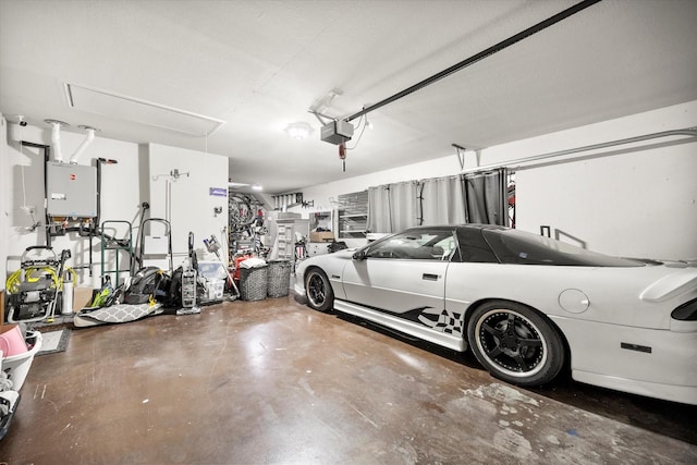 garage featuring water heater and a garage door opener