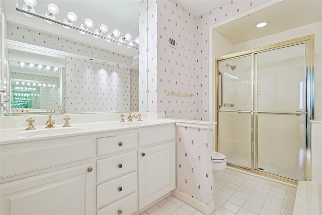 bathroom featuring a stall shower, tile patterned flooring, a sink, and wallpapered walls