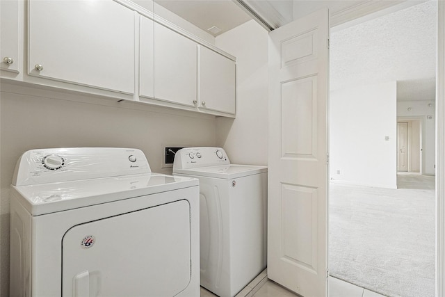 laundry room featuring light colored carpet, cabinet space, and separate washer and dryer