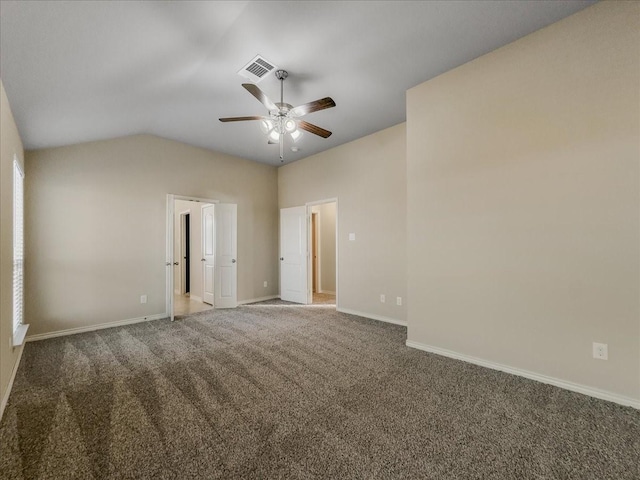 spare room with ceiling fan, lofted ceiling, visible vents, baseboards, and carpet