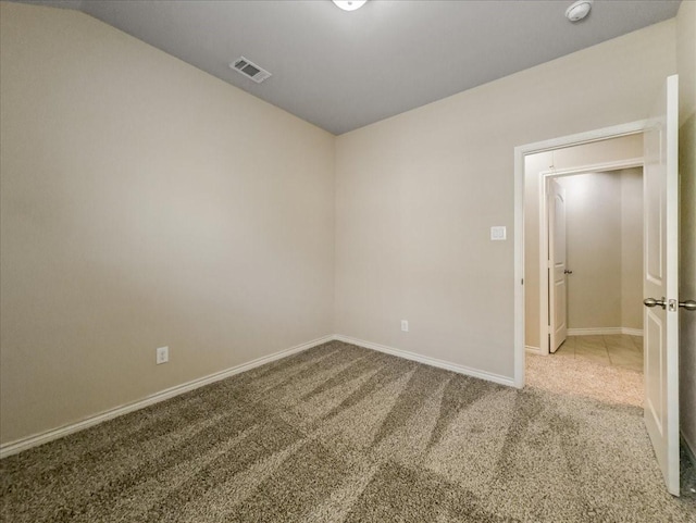 unfurnished room featuring carpet floors, baseboards, and visible vents