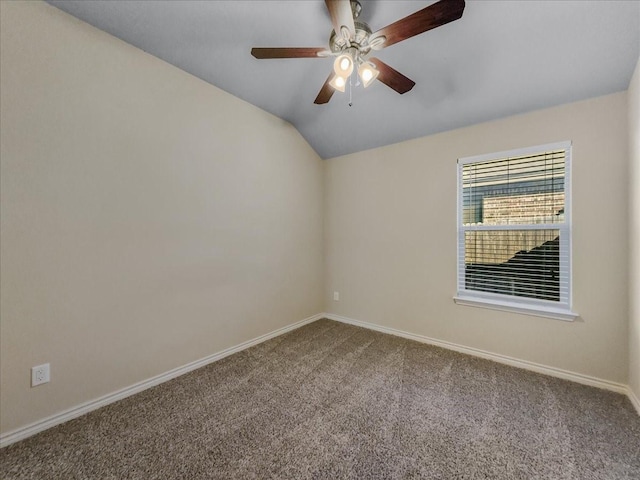 unfurnished room with carpet floors, baseboards, vaulted ceiling, and a ceiling fan