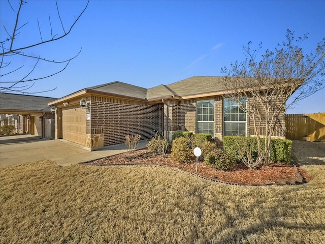 single story home with a garage, fence, concrete driveway, and brick siding