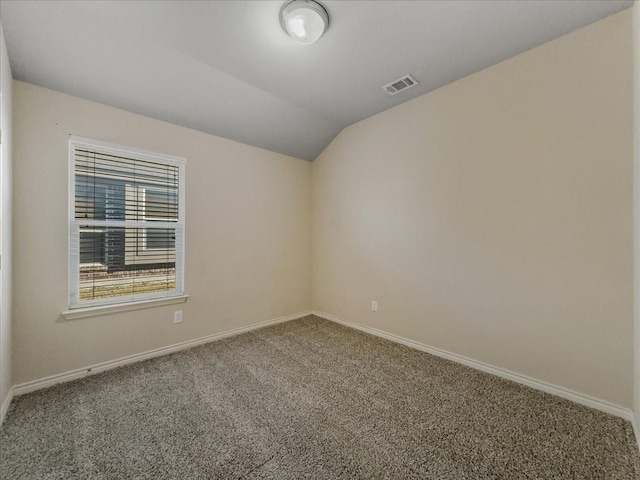 unfurnished room with baseboards, visible vents, vaulted ceiling, and carpet flooring