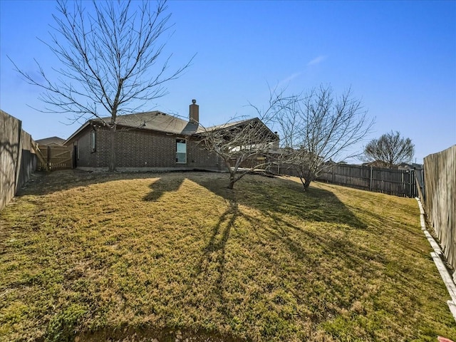 view of yard with a fenced backyard