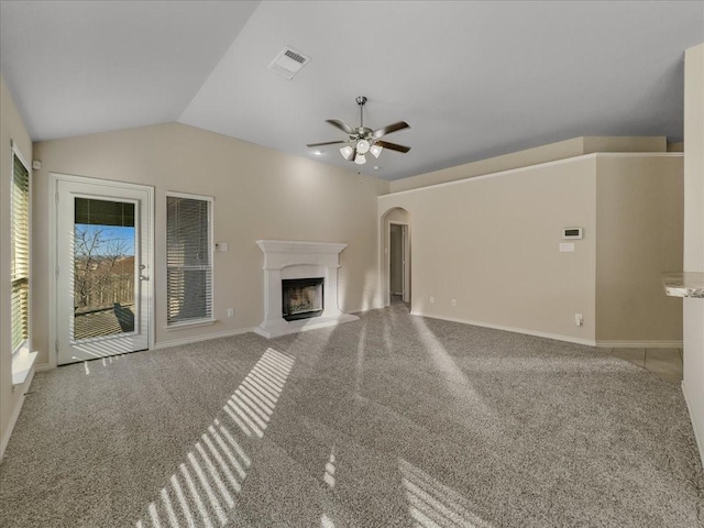 9228 Hunters Ct, White Settlement, TX 76108 - unfurnished living room featuring ceiling fan, arched walkways, a fireplace with raised hearth, carpet flooring, and lofted ceiling