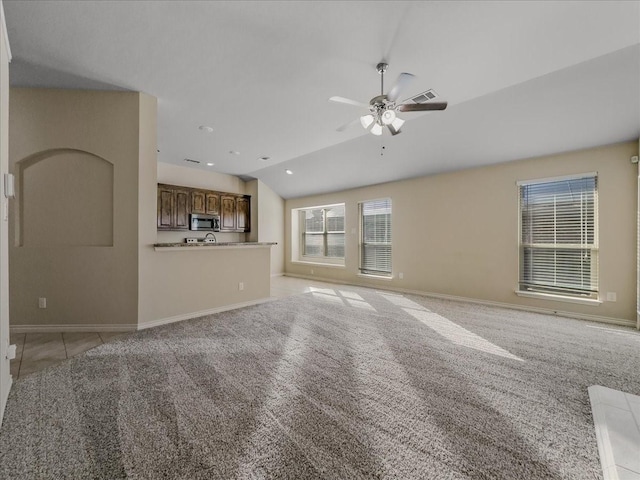 9228 Hunters Ct, White Settlement, TX 76108 - unfurnished living room featuring ceiling fan, light colored carpet, lofted ceiling, and baseboards