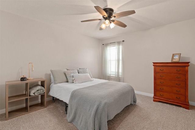 bedroom with baseboards, ceiling fan, and light colored carpet