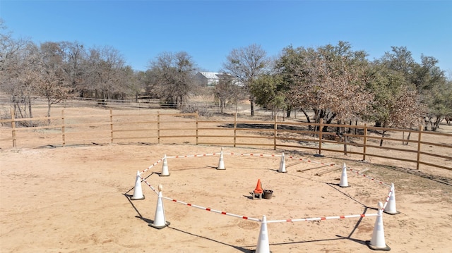 view of yard with a rural view and fence