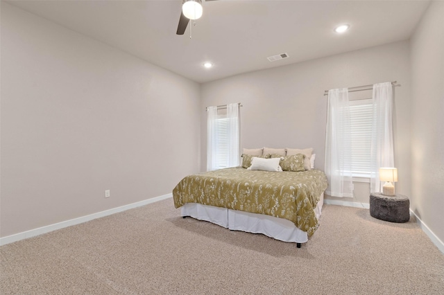 carpeted bedroom featuring a ceiling fan, recessed lighting, visible vents, and baseboards