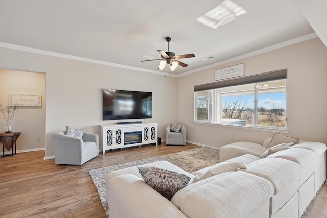 10112 Parkcrest Ct, Denton, TX 76207 - living area with crown molding, light wood-style flooring, ceiling fan, and baseboards