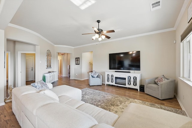 10112 Parkcrest Ct, Denton, TX 76207 - living area featuring visible vents, crown molding, wood finished floors, baseboards, and ceiling fan