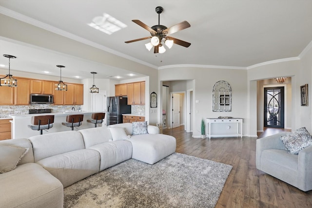 10112 Parkcrest Ct, Denton, TX 76207 - living area with crown molding, a ceiling fan, baseboards, and dark wood finished floors