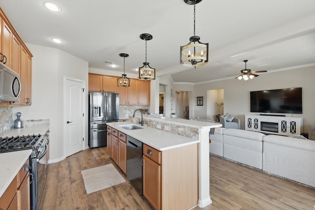 10112 Parkcrest Ct, Denton, TX 76207 - kitchen featuring a sink, ceiling fan with notable chandelier, backsplash, and stainless steel appliances