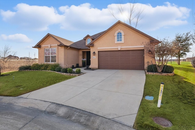 ranch-style house with driveway, a garage, a front yard, and stucco siding