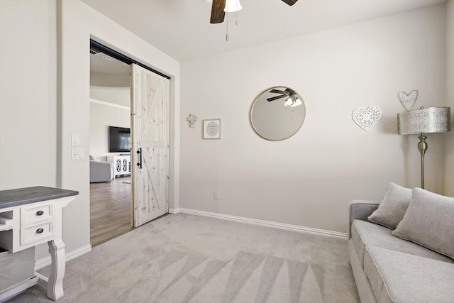 10112 Parkcrest Ct, Denton, TX 76207 - living area with baseboards, ceiling fan, carpet flooring, and a barn door