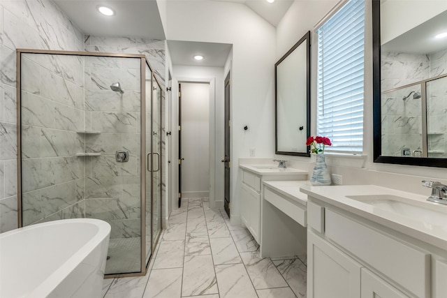 bathroom with a sink, marble finish floor, a freestanding bath, and a stall shower