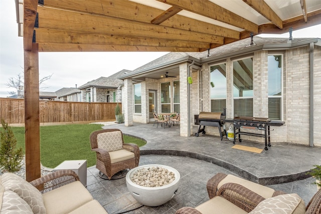 view of patio featuring fence and a ceiling fan