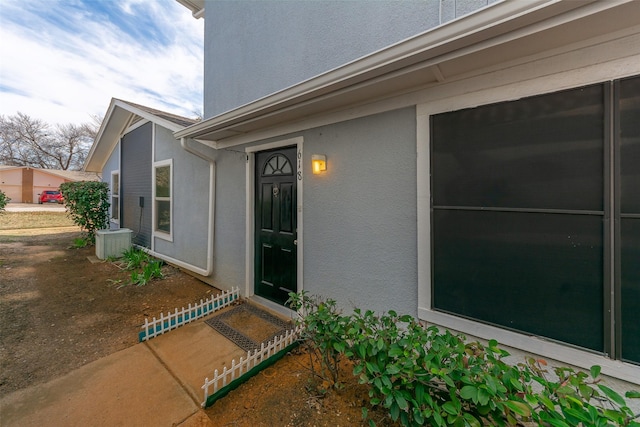 entrance to property featuring stucco siding