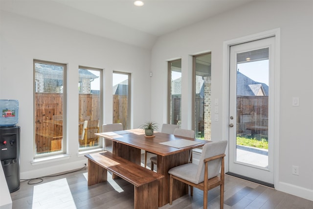 dining space with baseboards, wood finished floors, and recessed lighting