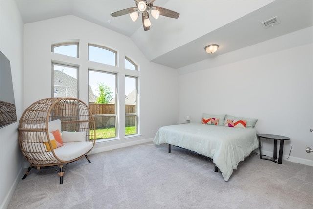 bedroom featuring lofted ceiling, light colored carpet, visible vents, and baseboards