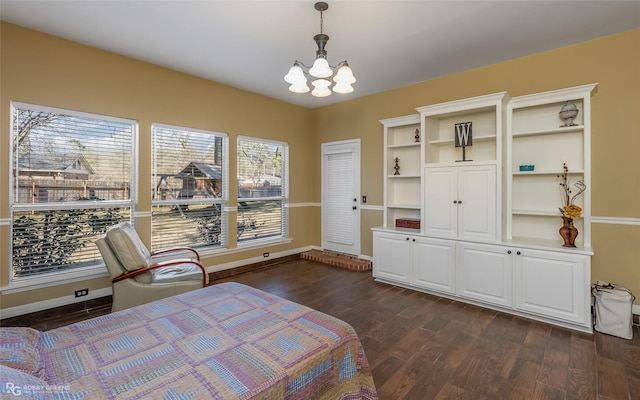 bedroom featuring an inviting chandelier, baseboards, and dark wood-style flooring