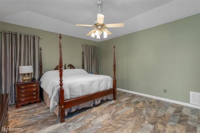 bedroom with baseboards, visible vents, a ceiling fan, and stone finish flooring