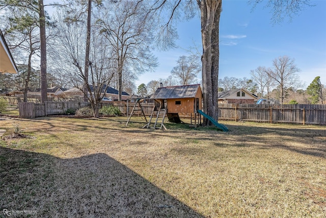 view of yard featuring a playground and a fenced backyard