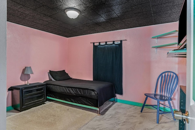 bedroom featuring baseboards