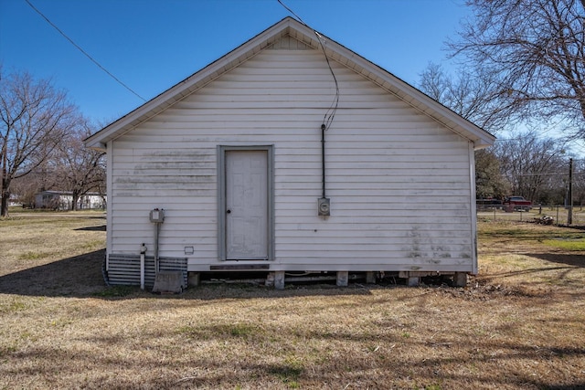 rear view of property with a yard