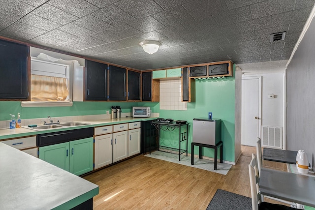 kitchen featuring light countertops, visible vents, and light wood-style flooring