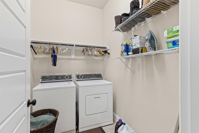 laundry room with laundry area, washer and dryer, and tile patterned floors