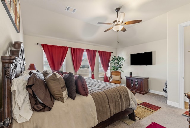 carpeted bedroom with baseboards, visible vents, and ceiling fan