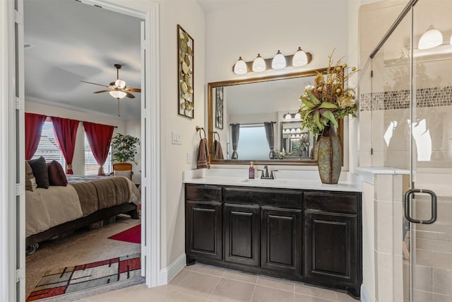 ensuite bathroom featuring a ceiling fan, ensuite bath, tile patterned flooring, vanity, and a shower stall