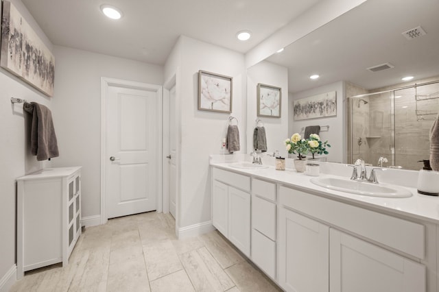 bathroom featuring a sink, visible vents, and a shower stall