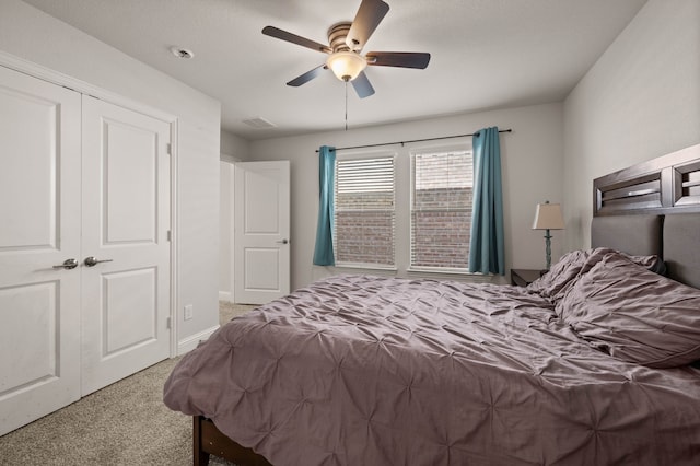 carpeted bedroom featuring a closet, a ceiling fan, and baseboards