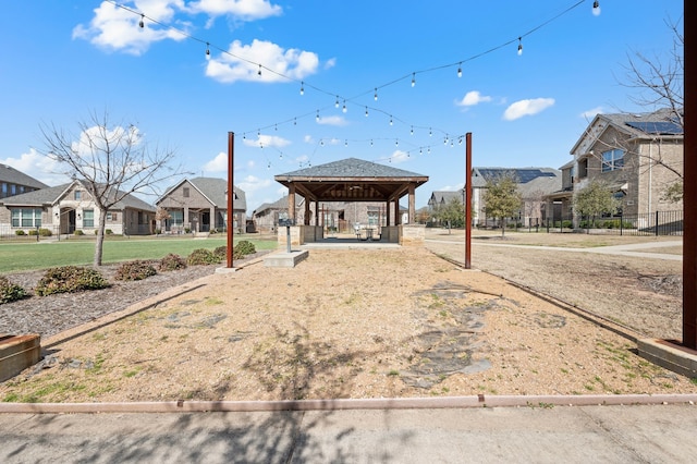 view of home's community featuring a residential view, fence, and a gazebo