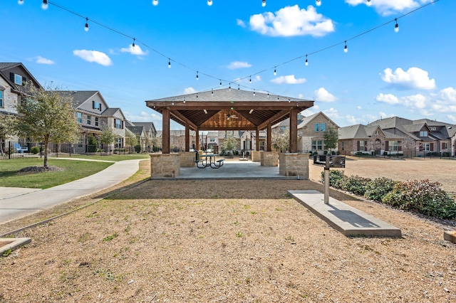 surrounding community with a residential view, a yard, fence, a gazebo, and a patio area