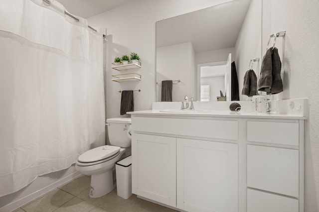 bathroom featuring toilet, vanity, and tile patterned floors