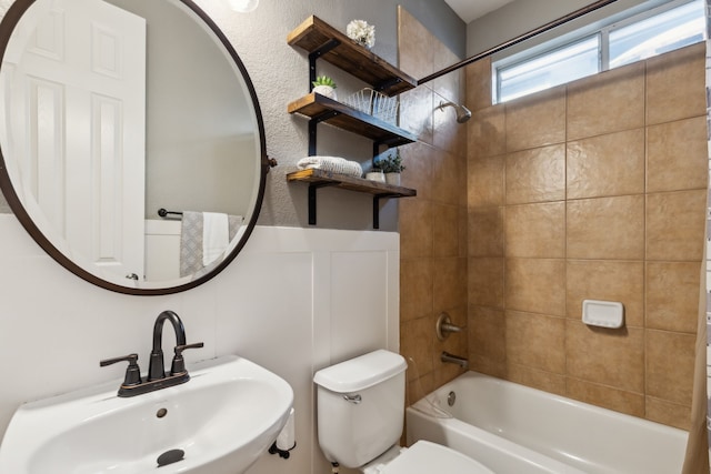 bathroom featuring shower / bath combination, a sink, and toilet