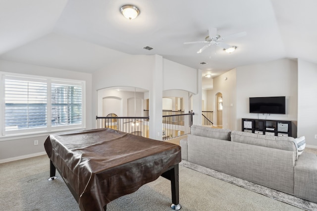 rec room with lofted ceiling, arched walkways, visible vents, and baseboards