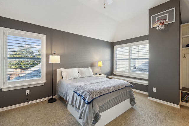 carpeted bedroom featuring lofted ceiling and baseboards