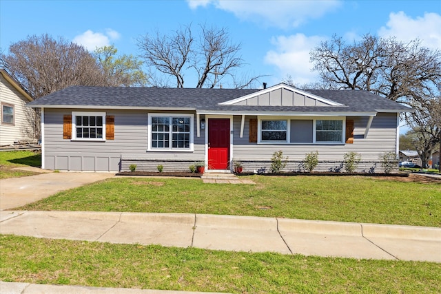 view of front of home with a front lawn, board and batten siding, and a shingled roof