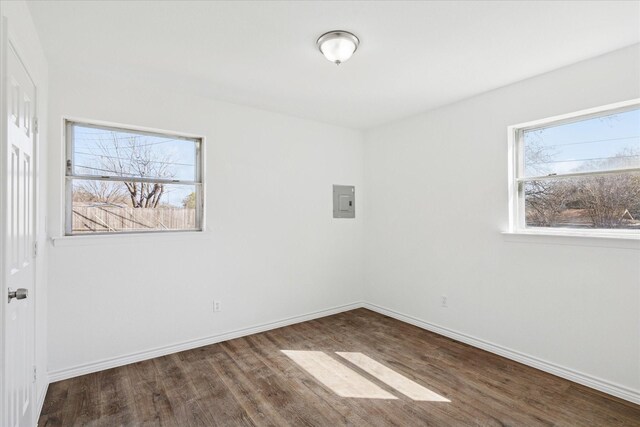 spare room featuring wood finished floors and baseboards