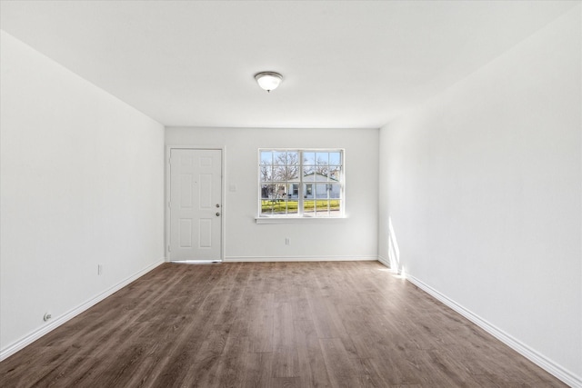 spare room with wood finished floors and baseboards