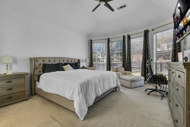 bedroom with lofted ceiling, visible vents, a ceiling fan, and light colored carpet