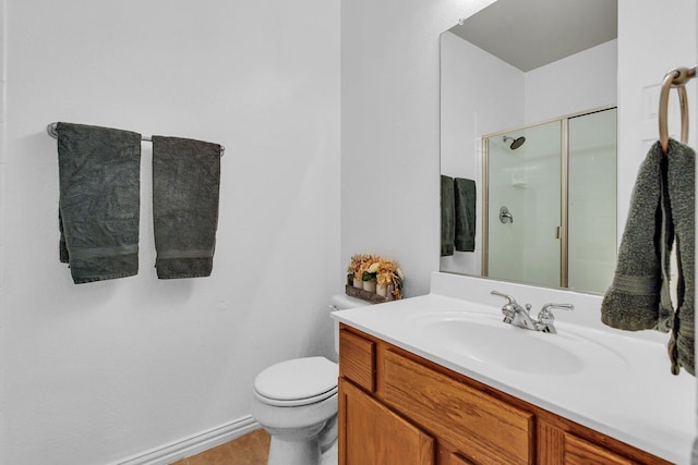 bathroom featuring toilet, a stall shower, and vanity