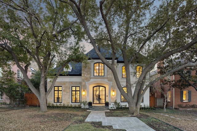 view of front of home with stone siding and french doors