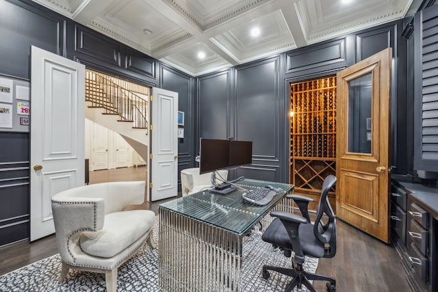 home office with beam ceiling, crown molding, a decorative wall, dark wood-type flooring, and coffered ceiling