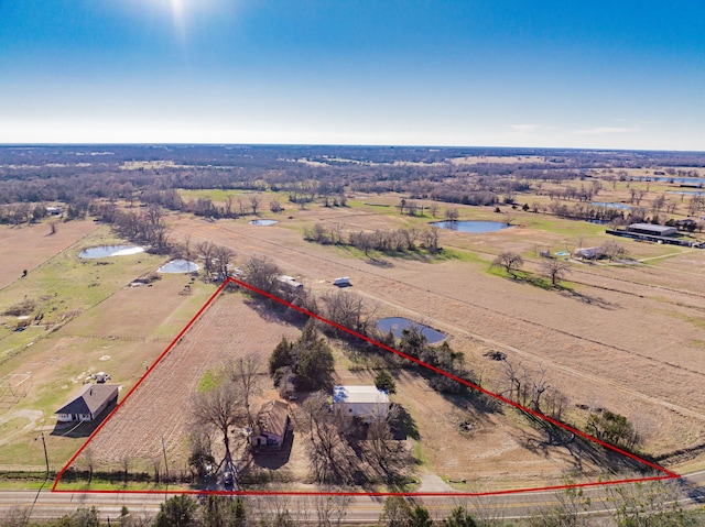 birds eye view of property featuring a water view and a rural view